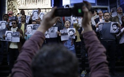 Journalists hold placards of